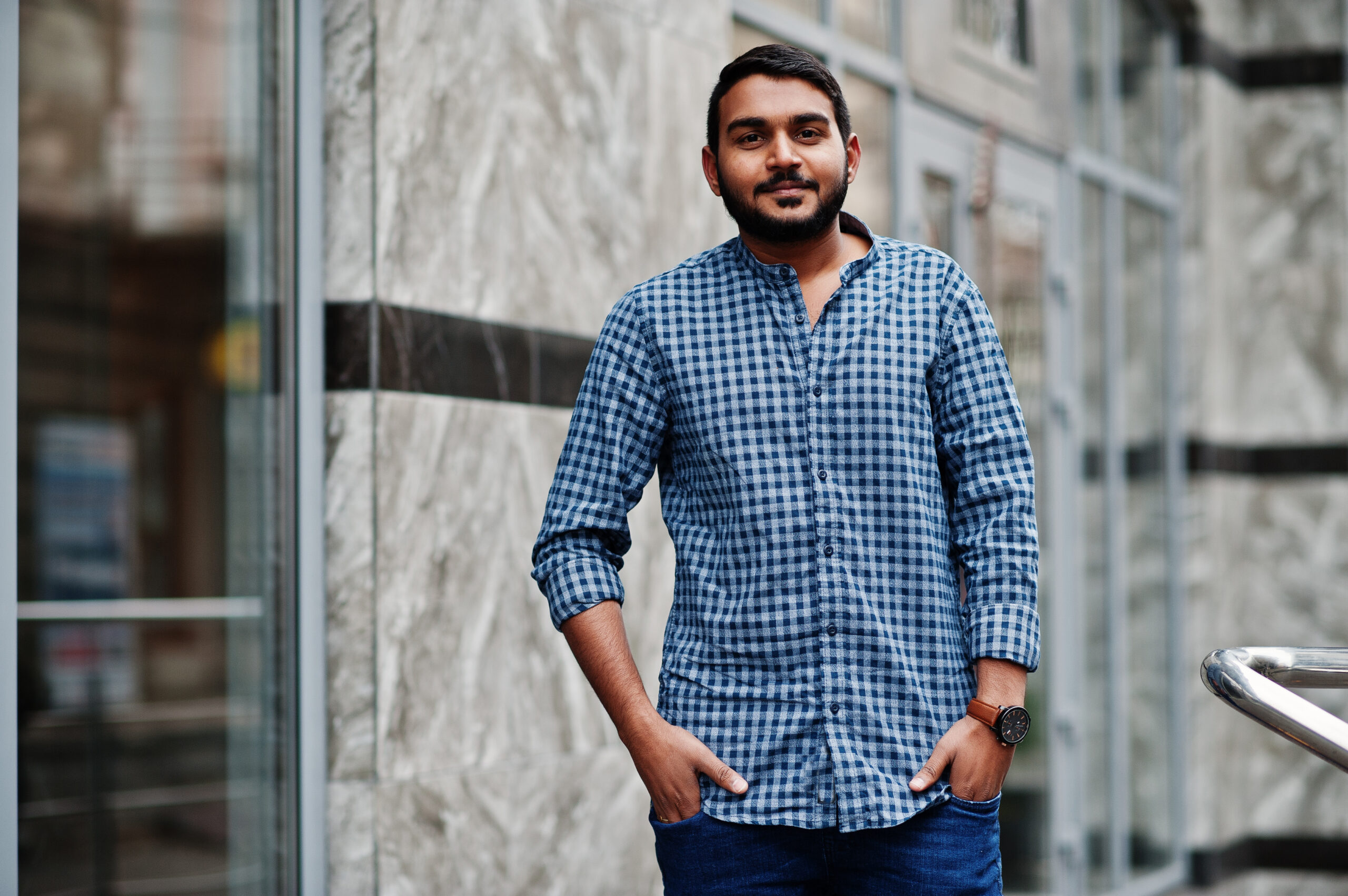 Stylish indian beard model man in casual clothes posed outdoor at street of India.